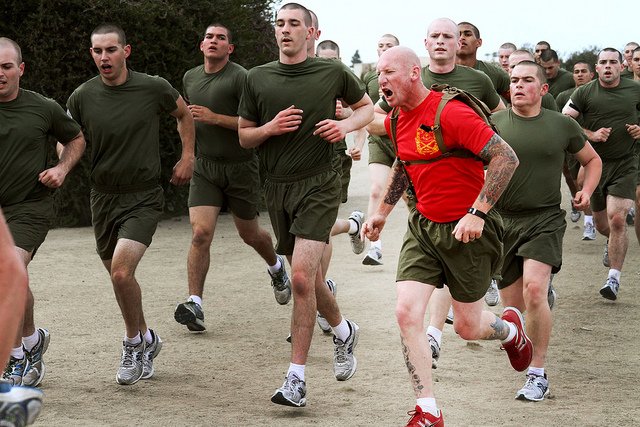 Drill instructors of Company C, 1st Recruit Trianing Battalion, encourage recruits to exert maximum effort to excel during the quarter-mile sprint exercise aboard Marine Corps Recruit Depot San Diego April 16.
